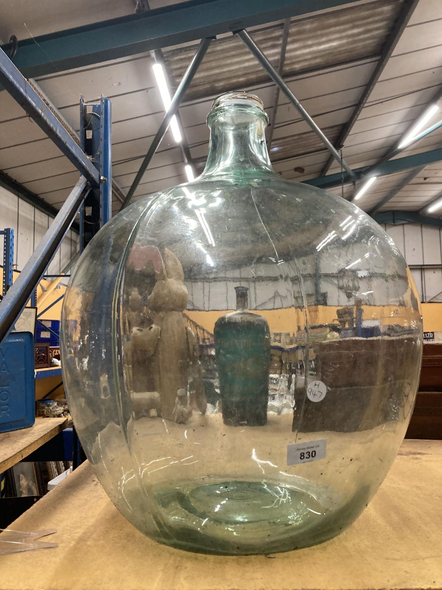 A VERY LARGE VINTAGE GLASS CARBOY BOTTLE, HEIGHT APPROX 60CM, DIAMETER AT THE MIDDLE APPROX 40CM