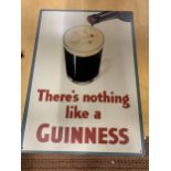 A LARGE METAL GUINNESS SIGN