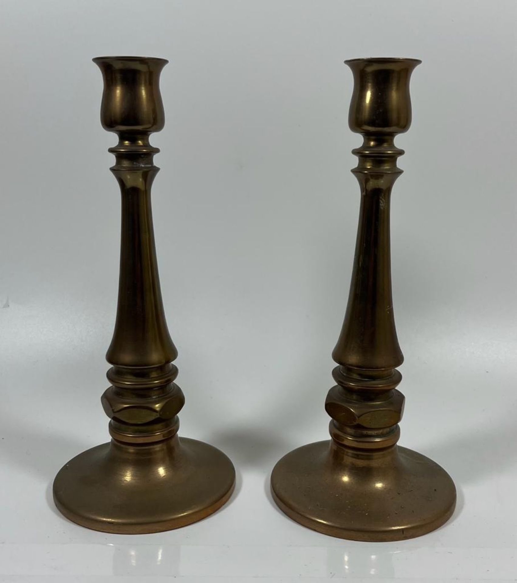 A VINTAGE PAIR OF CHURCH GOTHIC CANDLESTICKS WITH SCREW IN HOLE TO THE BASE POSSIBLY FOR AN ALTAR,