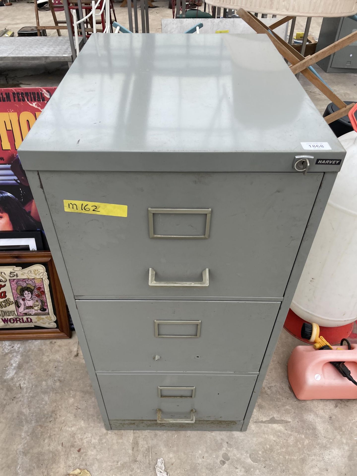 A THREE DRAWER METAL FILING CABINET