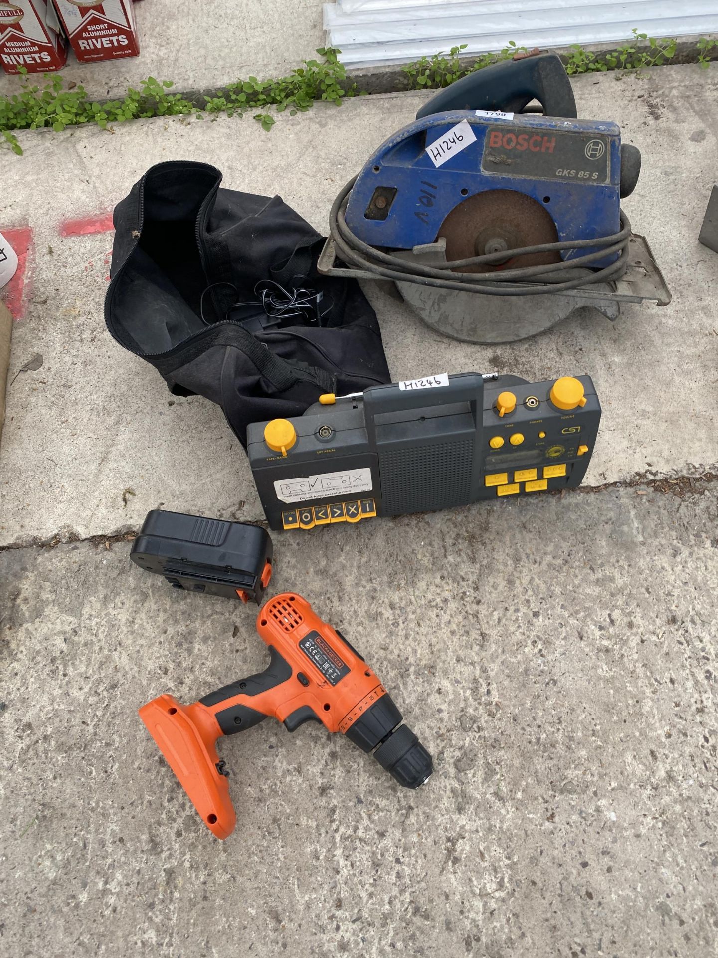 AN ASSORTMENT O TOOLS TO INCLUDE A BOSCH RIP SAW AND A BLACK AND DECKER DRILL ETC