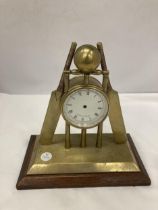 A BRASS MANTLE CLOCK FASHIONED AS CRICKET BATS, STUMPS AND BALL -A/F NO MOVEMENT HEIGHT 22CM