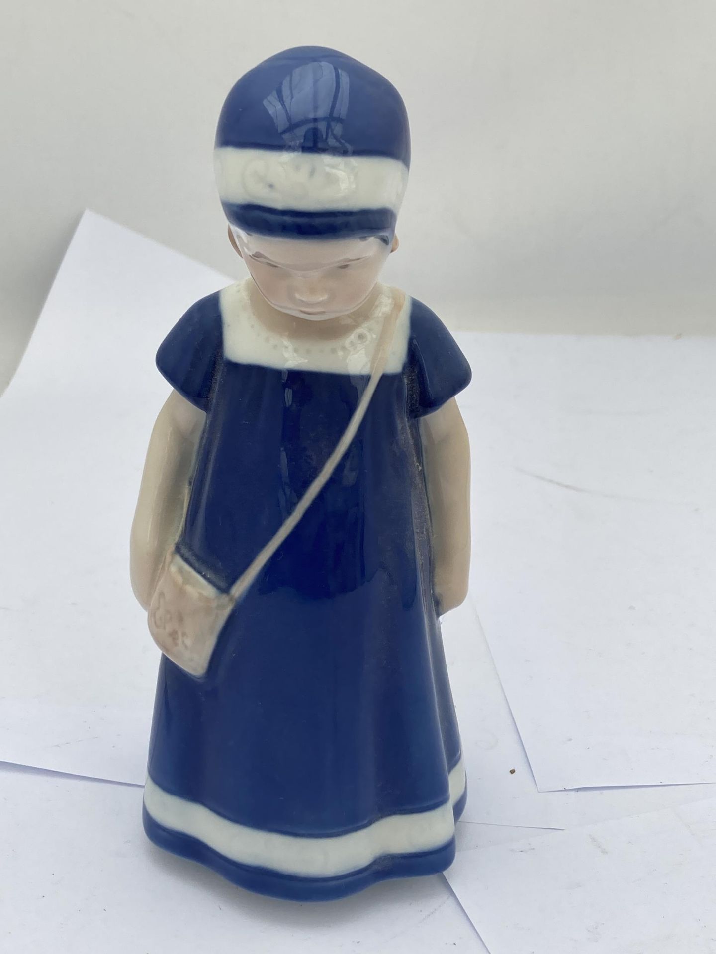 A ROYAL COPENHAGEN FIGURE OF A GIRL IN A BLUE DRESS