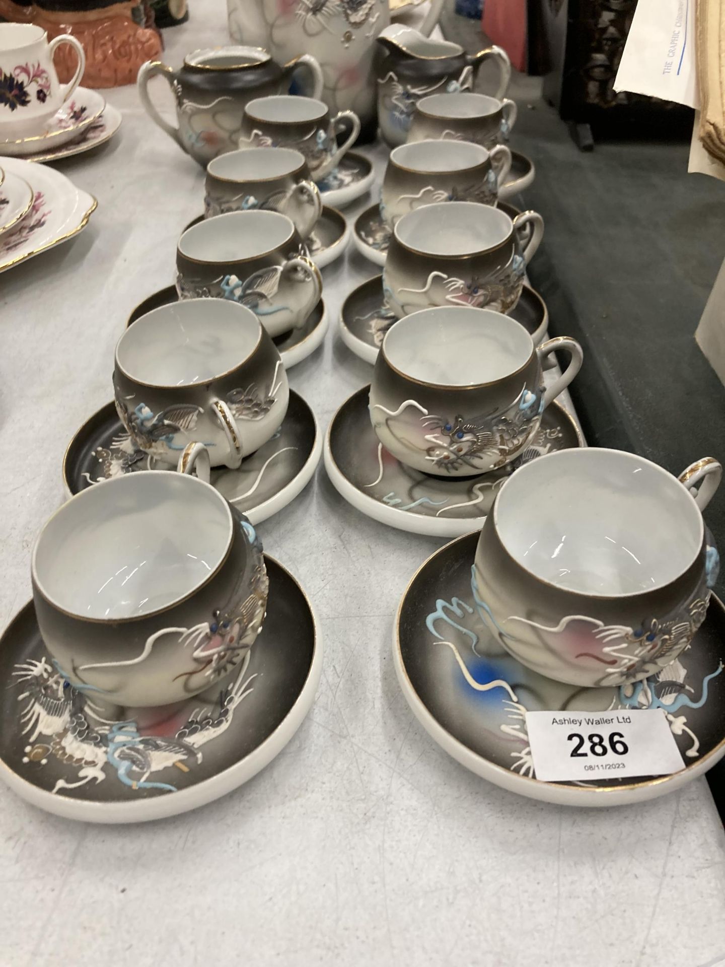 A JAPANESE 'KUTANI' CHINA COFFEE SET WITH DRAGON PATTERN AND TRANSLUCENT BASE TO THE CUPS WITH AN - Image 2 of 3