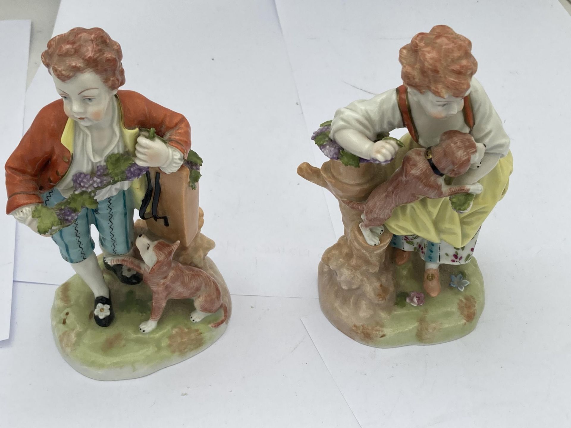 A PAIR OF ANTIQUE CONTINENTAL DRESDEN FIGURES OF BOHYS WITH DOGS, IMPRESSED MARKS TO BASE