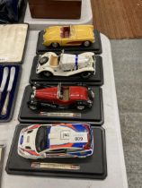 FOUR LARGE DIE-CAST CARS ON PLINTHS, A FORD, BUGATTI, MERCEDES AND A CHEVROLET