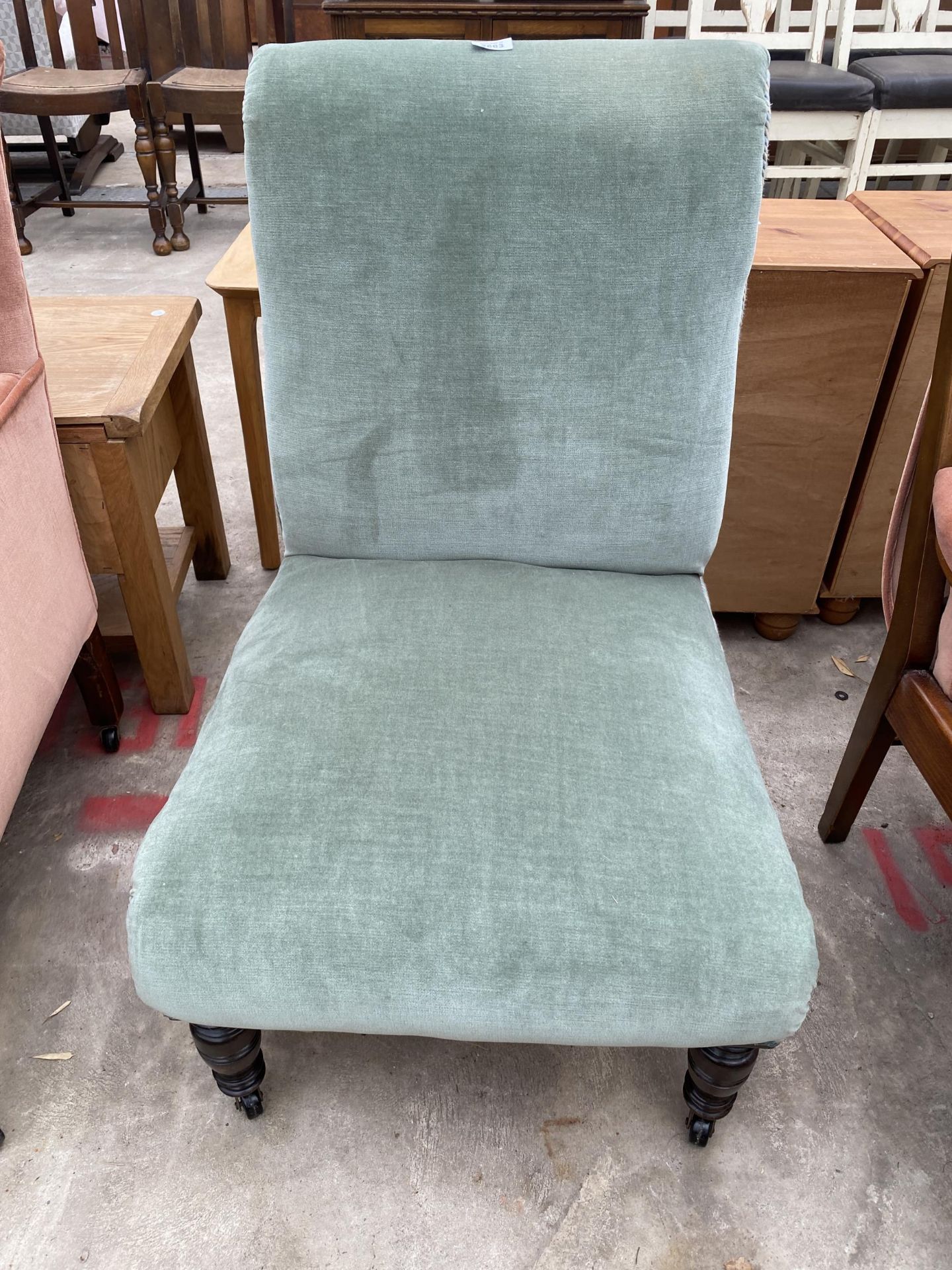 A LATE VICTORIAN ARMLESS NURSING CHAIR ON TURNED FRONT LEGS