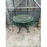 A CAST ALLOY BISTRO SET COMPRISING OF A ROUND TABLE AND TWO CARVER CHAIRS