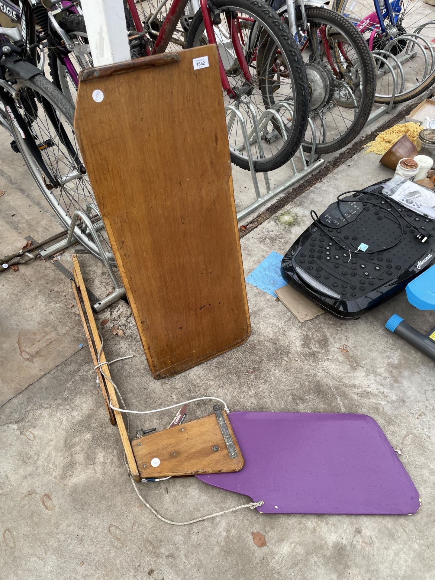 A VINTAGE WOODEN BOAT RUDDER AND A FURTHER SECTION OF BOAT