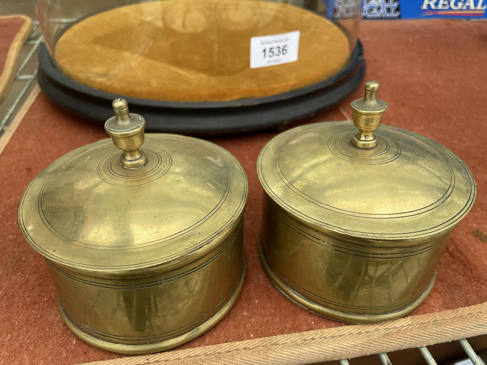 A PAIR OF BRASS INK WELLS WITH GLASS LINERS