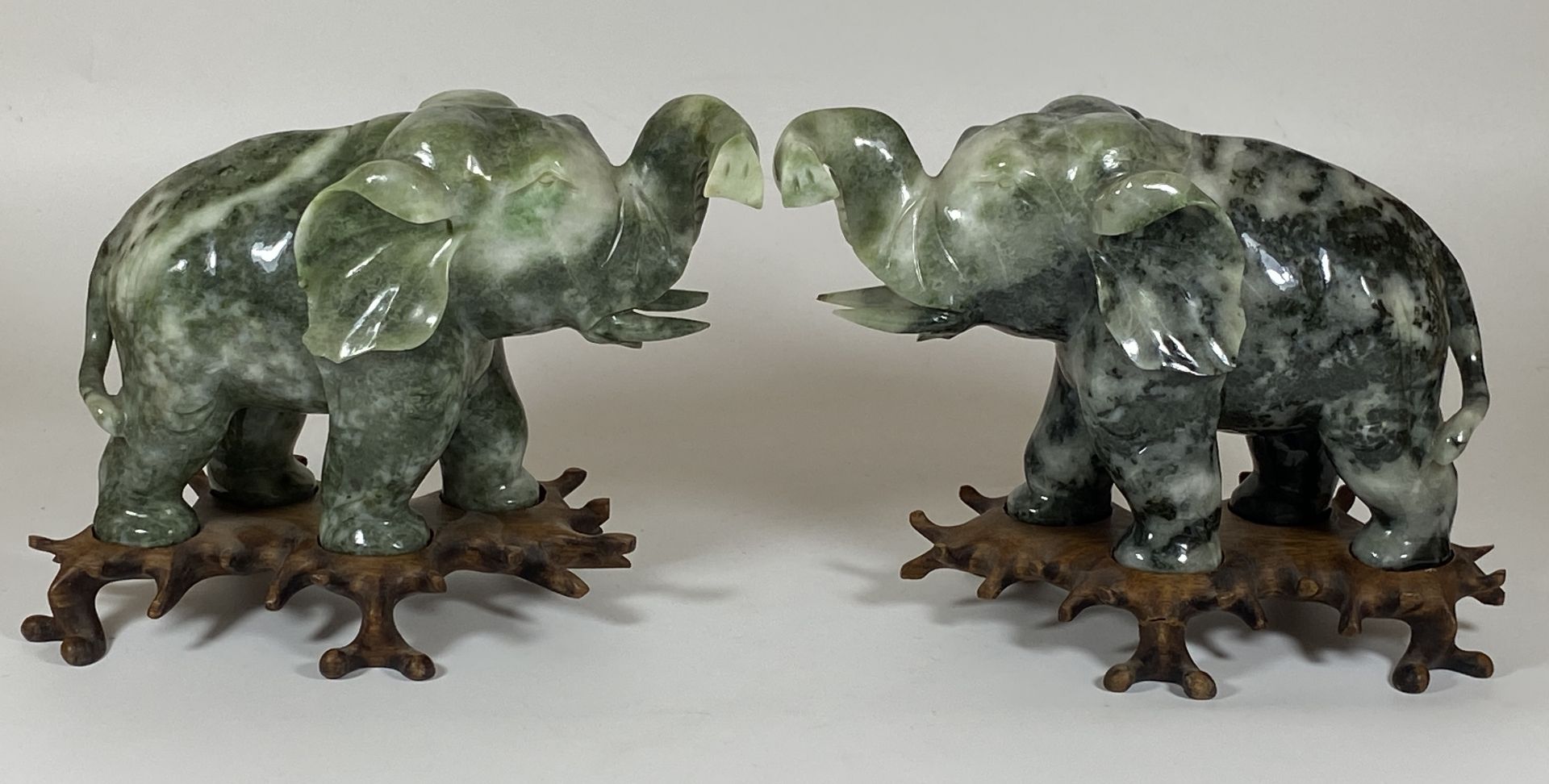 A PAIR OF GREAT QUALITY ORIENTAL CHINESE JADE JADEITE HARDSTONE ELEPHANTS ON CARVED WOODEN BASES,