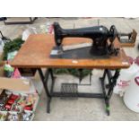 A LARGE VINTAGE SINGER SEWING MACHINE WITH TREDDLE BASE