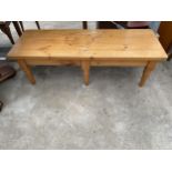 A PINE COFFEE TABLE ON SIX TURNED TAPERING LEGS, 51.5 X 18"