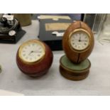 TWO HISTORY CRAFT DESK CLOCKS IN THE FORM OF A CRICKET BALL AND RUGBY BALL