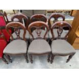 A SET OF SIX VICTORIAN STYLE MAHOGANY DINING CHAIRS ON TURNED AND FLUTED FRONT LEGS