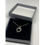 A SILVER BOXED NECKLACE WITH CLEAR STONE HEART PENDANT