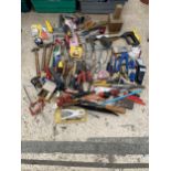 A LARGE ASSORTMENT OF HAND TOOLS TO INCLUDE SCREW DRIVERS, HAMMERS AND HACKSAWS ETC