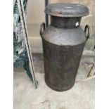 A VINTAGE CAST IRON MILK CHURN WITH LID