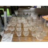 A LARGE QUANTITY OF GLASSWARE TO INCLUDE WINE GLASSES, SHERRY GLASSES, SHOT GLASSES, ETC.,