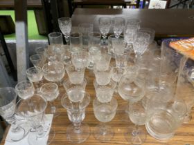 A LARGE QUANTITY OF GLASSWARE TO INCLUDE WINE GLASSES, SHERRY GLASSES, SHOT GLASSES, ETC.,