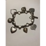 A MARKED SILVER CHARM BRACELET WITH EIGHT CHARMS