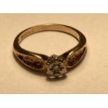 A 9 CARAT GOLD RING WITH A DIAMOND SOLITAIRE SIZE J