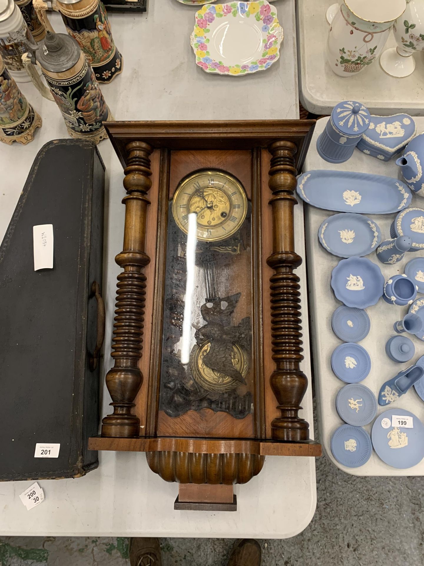 A MAHOGANY CASED VIENNA WALL CLOCK WITH EAGLE DESIGN TOP, WITH PENDULUM AND KEY