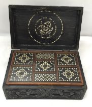 A VINTAGE CARVED DARK OAK JEWELLERY BOX WITH INNER SECTION WITH INLAID COMPARTMENT LIDS