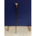 A VINTAGE WALKING STICK WITH GLASS TOP AND METAL BANDING