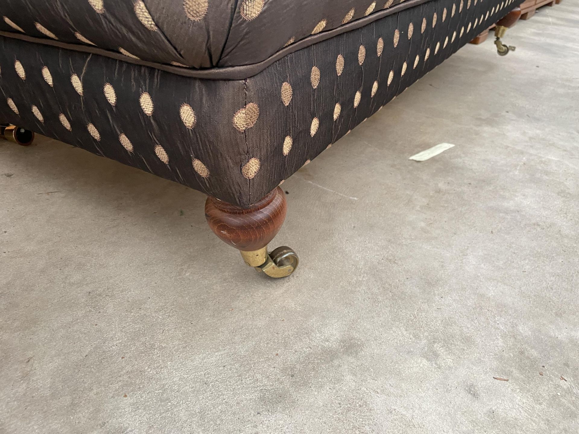 A VICTORIAN STYLE STOOL ON TURNED LEGS, WITH BRASS CASTERS AND POLKA DOT COVERING - Image 3 of 3