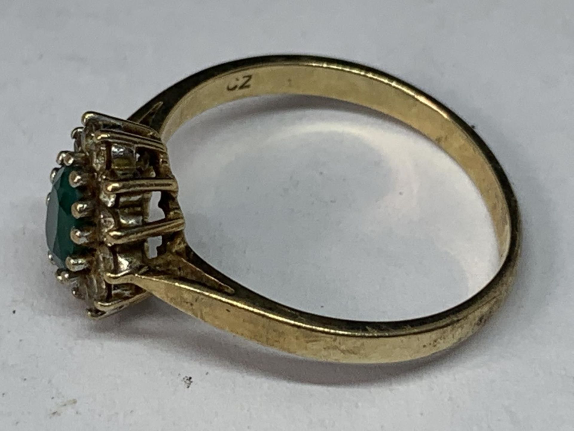 A 9 CARAT GOLD RING WITH CENTRE GREENSTONE SURROUNDED BY CUBIC ZIRCONIAS SIZE P - Image 2 of 3
