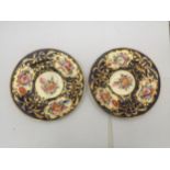 A PAIR OF 19TH CENTURY PORCELAIN BLUE AND GILT HAND PAINTED PLATES