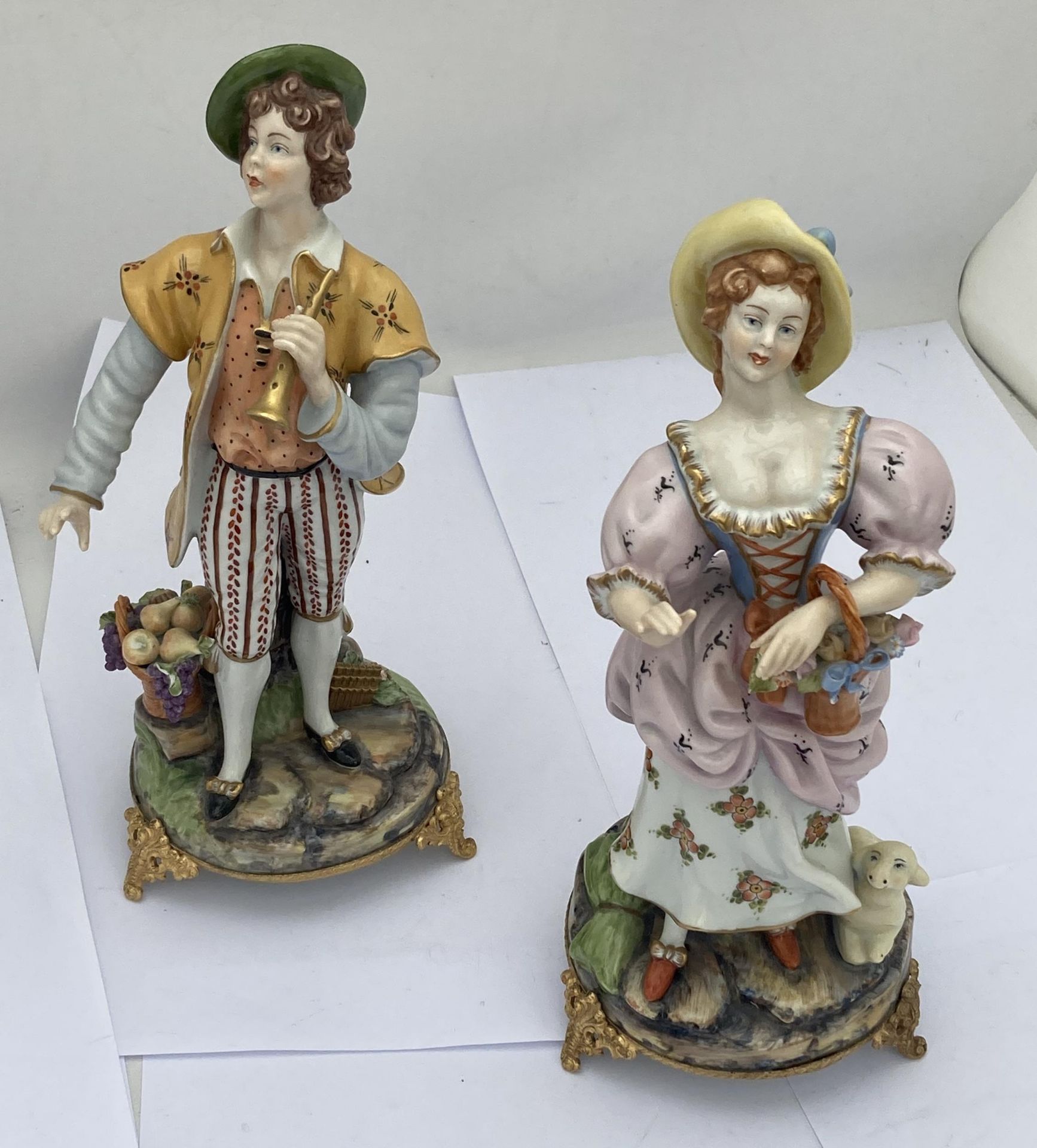 A PAIR OF CAPODIMONTE ITALIAN FIGURES OF A BOY AND GIRL, NUMBERED 2034 & 2035 ON GILT METAL BASES