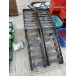 A PAIR OF HEAVY DUTY METAL CAR RAMPS AND A WHEEL BRACE