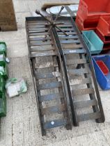 A PAIR OF HEAVY DUTY METAL CAR RAMPS AND A WHEEL BRACE