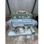 A JONES ELECTRIC SINGER SEWING MACHINE WITH CARRY CASE