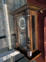 A MAHOGANY CHIMING WALL CLOCK