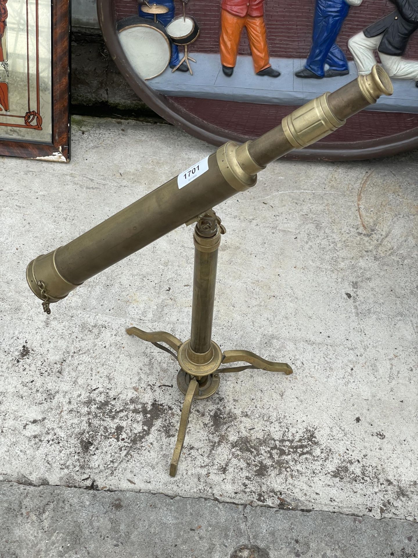 A VINTAGE BRASS TELESCOPE ON A TRIPOD STAND