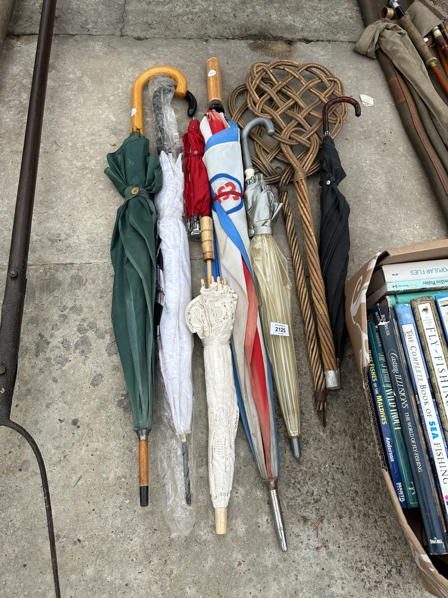 AN ASSORTMENT OF UMBRELLAS AND TWO CARPET BEATERS