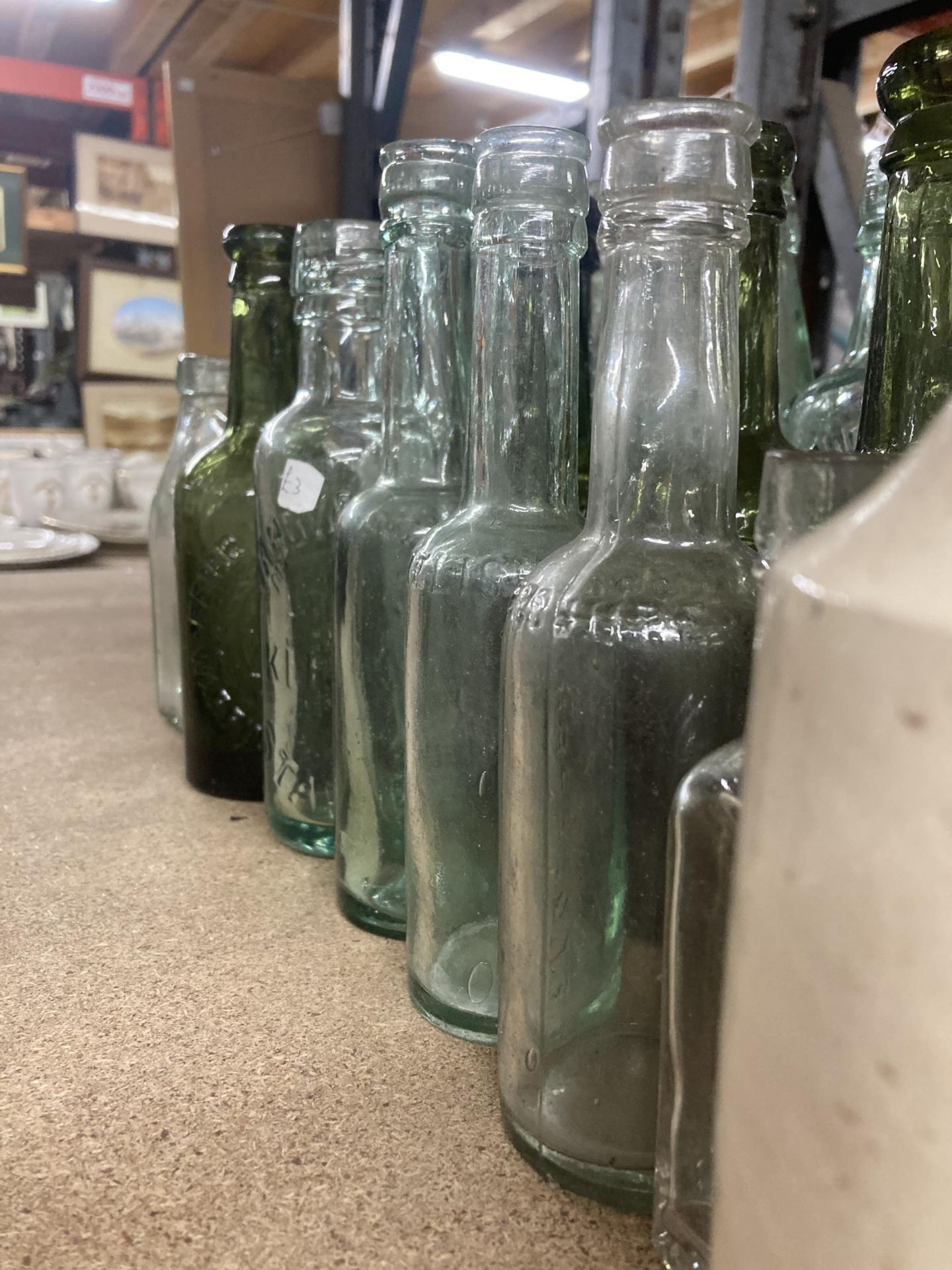 A COLLECTION OF VINTAGE GLASS BOTTLES WITH ADVERTISING ON THEM PLUS TWO STONE ONES - Image 2 of 4