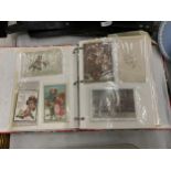 A VINTAGE POSTCARD ALBUM WITH ASSORTED CARDS