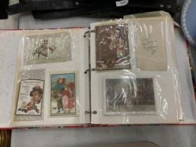 A VINTAGE POSTCARD ALBUM WITH ASSORTED CARDS
