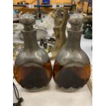 A PAIR OF DUTCH AMBER COLOURED THREE SIDED DECANTERS WITH PEWTER BASE AND TOP, HEIGHT 25CM