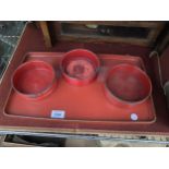 THREE LACQUERED ANTIQUE WINE COASTERS AND A LACQUERED TRAY