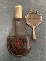 A VINTAGE SILVER PLATED VANITY SET IN A TOOLED LEATHER SLEEVE