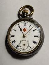 A LADIES RED CROSS POCKET WATCH WITH WHITE ENAMEL FACE AND ROMAN NUMERALS SEEN WORKING BUT NO