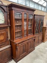 A VICTORIAN MAHOGANY THREE DOOR BOOKCASE ON BASE, 55" WIDE, WITH DRAWER AND CUPBOARDS TO BASE