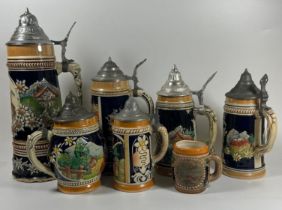 A COLLECTION OF SEVEN VINTAGE GERMAN BEER STEINS, LARGEST 28 CM