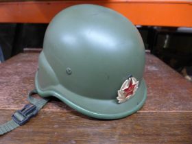 A RUSSIAN TANK HELMET WITH LINER AND BADGE