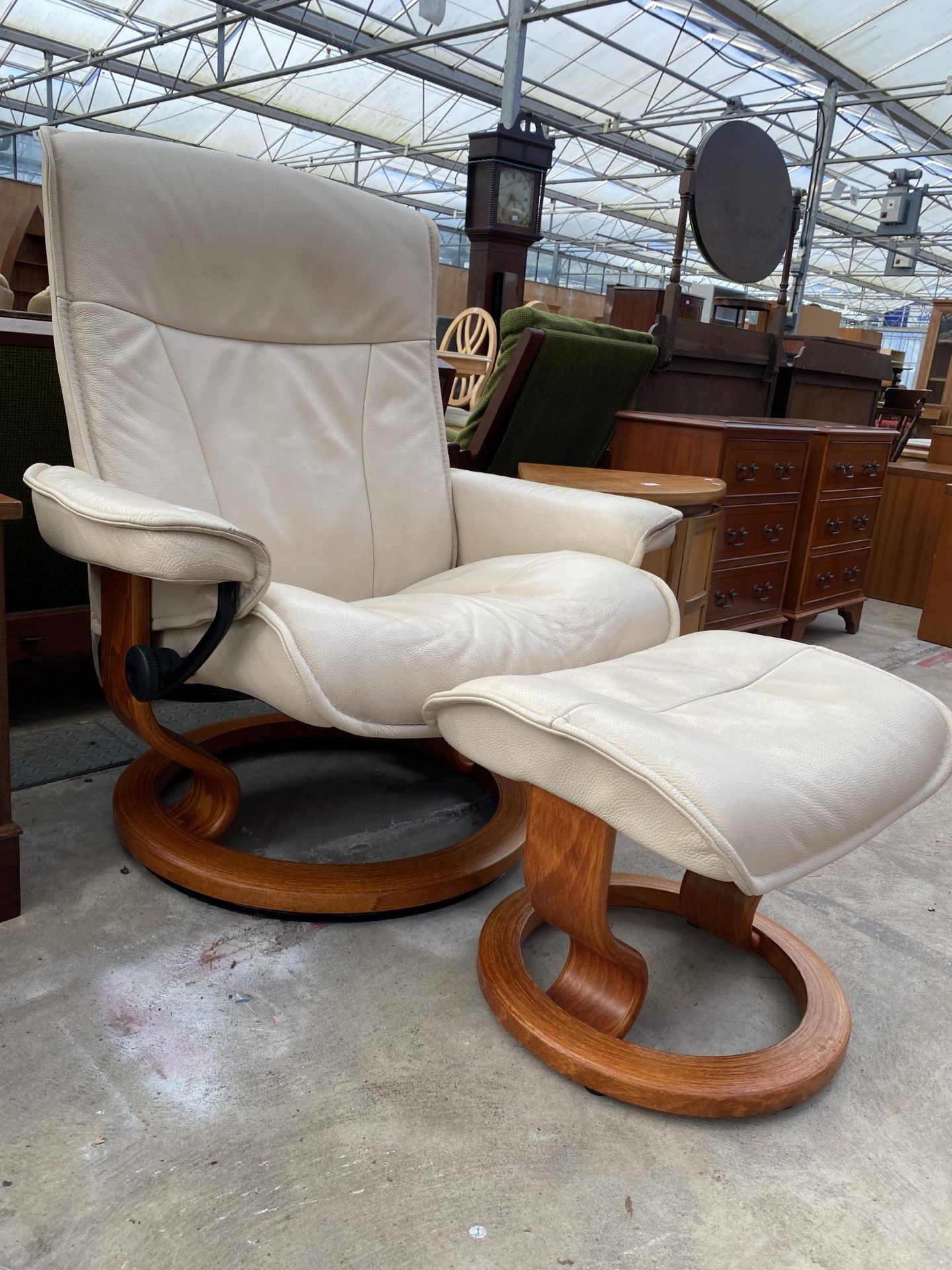 A STRESSLESS RECLINING SWIVEL CHAIR AND MATCHING STOOL - Image 2 of 3